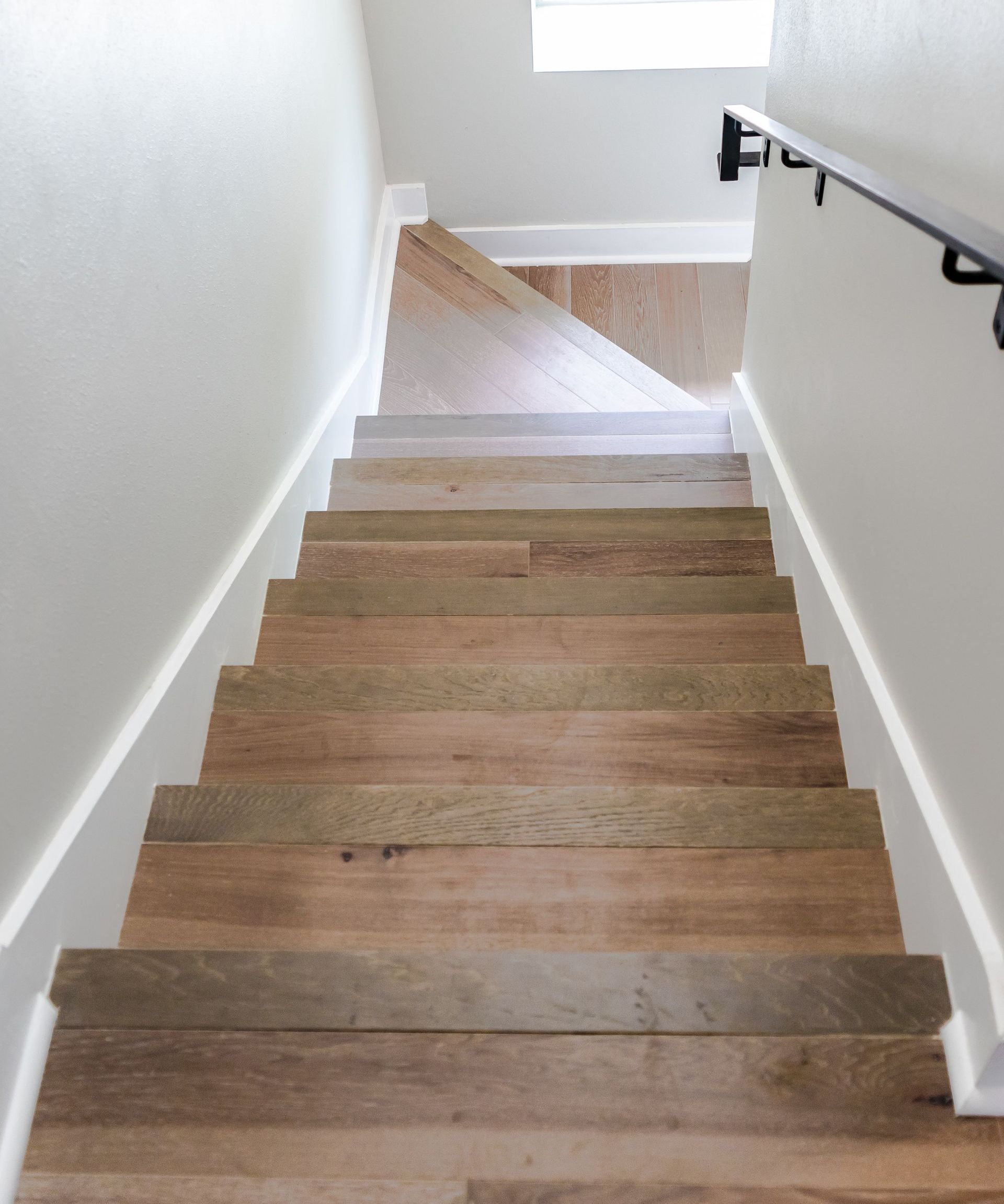 The stairs are made of wood and have a metal railing