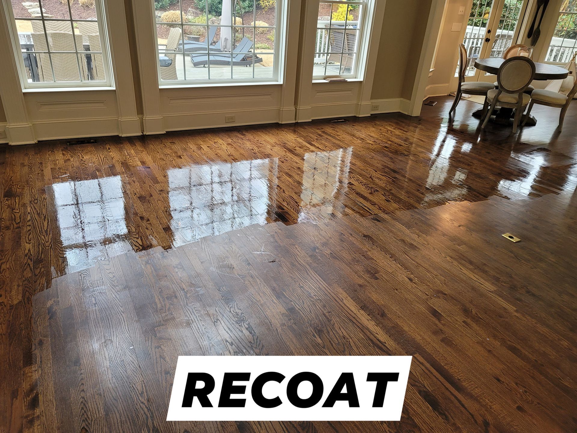 A living room with hardwood floors being recoated.