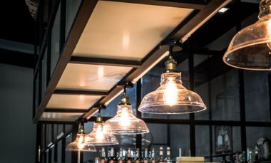 Row of warm pendant lights hanging in a modern industrial interior