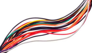 Bundle of multicolored wires curved diagonally on a white background
