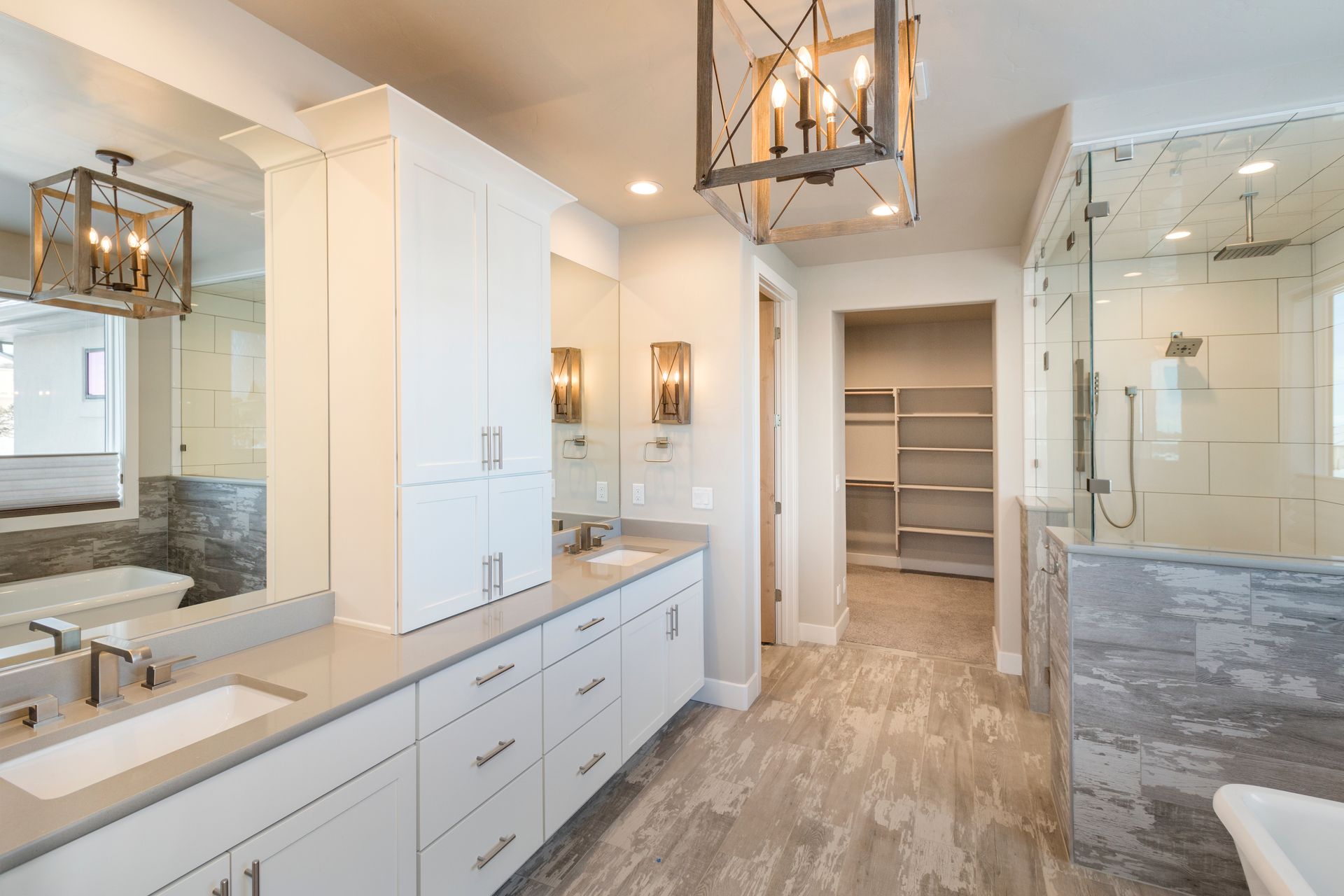 Spacious modern bathroom with double vanity, glass shower, and built-in shelves. Spacious modern bathroom with double vanity, glass shower, and built-in shelves.