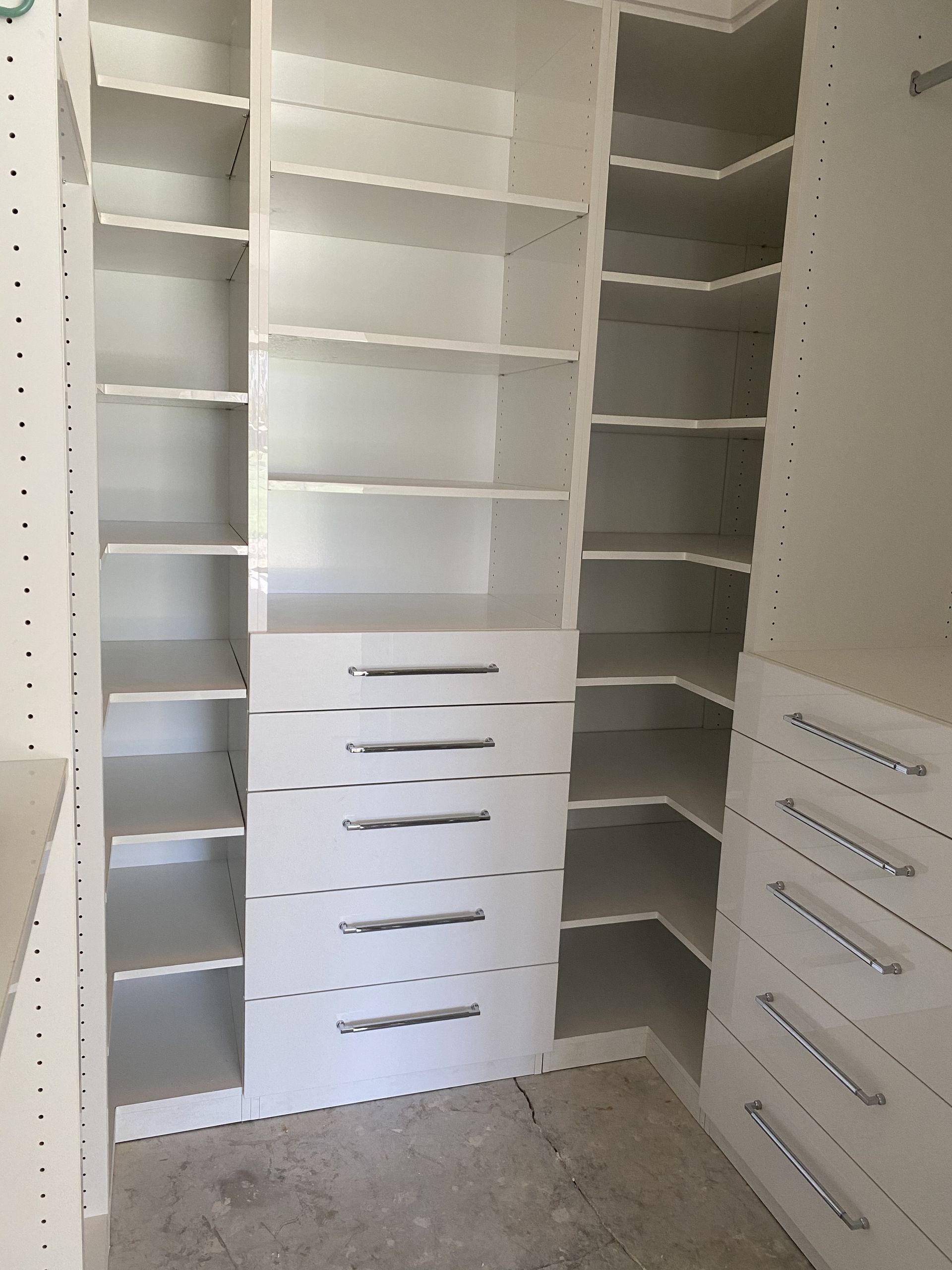 White custom closet with shelves and drawers.