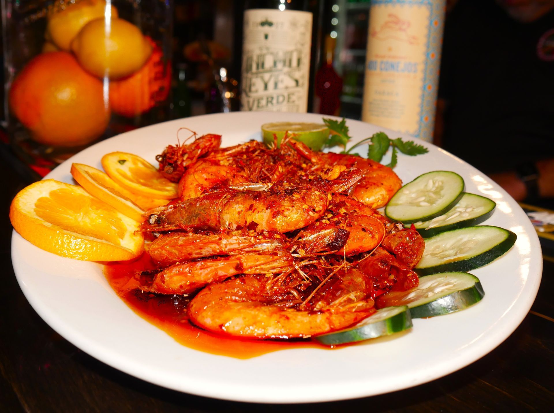 Lourdes' secret menu Camarones Cucaracha - butterflied shrimp in spicy sauce, garnished with fresh orange, cucumber, and lime