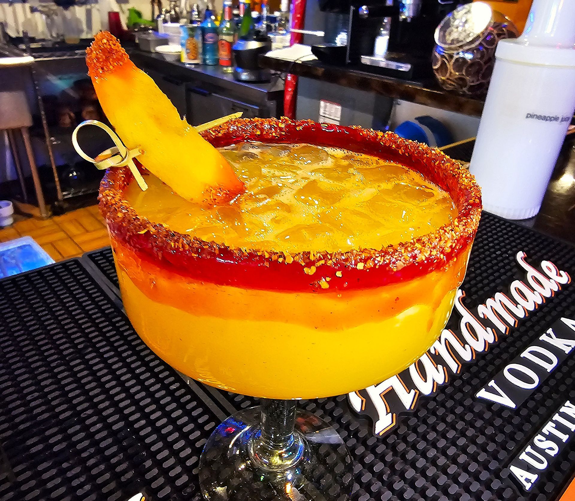 Signature jumbo mango margarita with tajín-crusted rim, fresh mango garnish - Taqueria El Chaparrito's viral drink