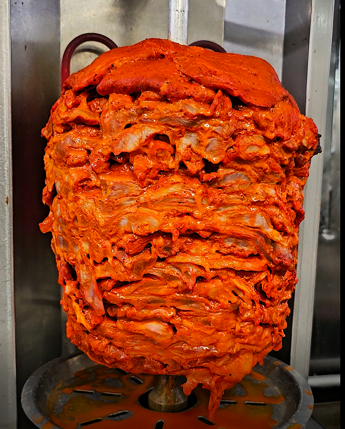 Authentic trompo al pastor marinated in traditional adobo spices - bringing Mexico to Michigan