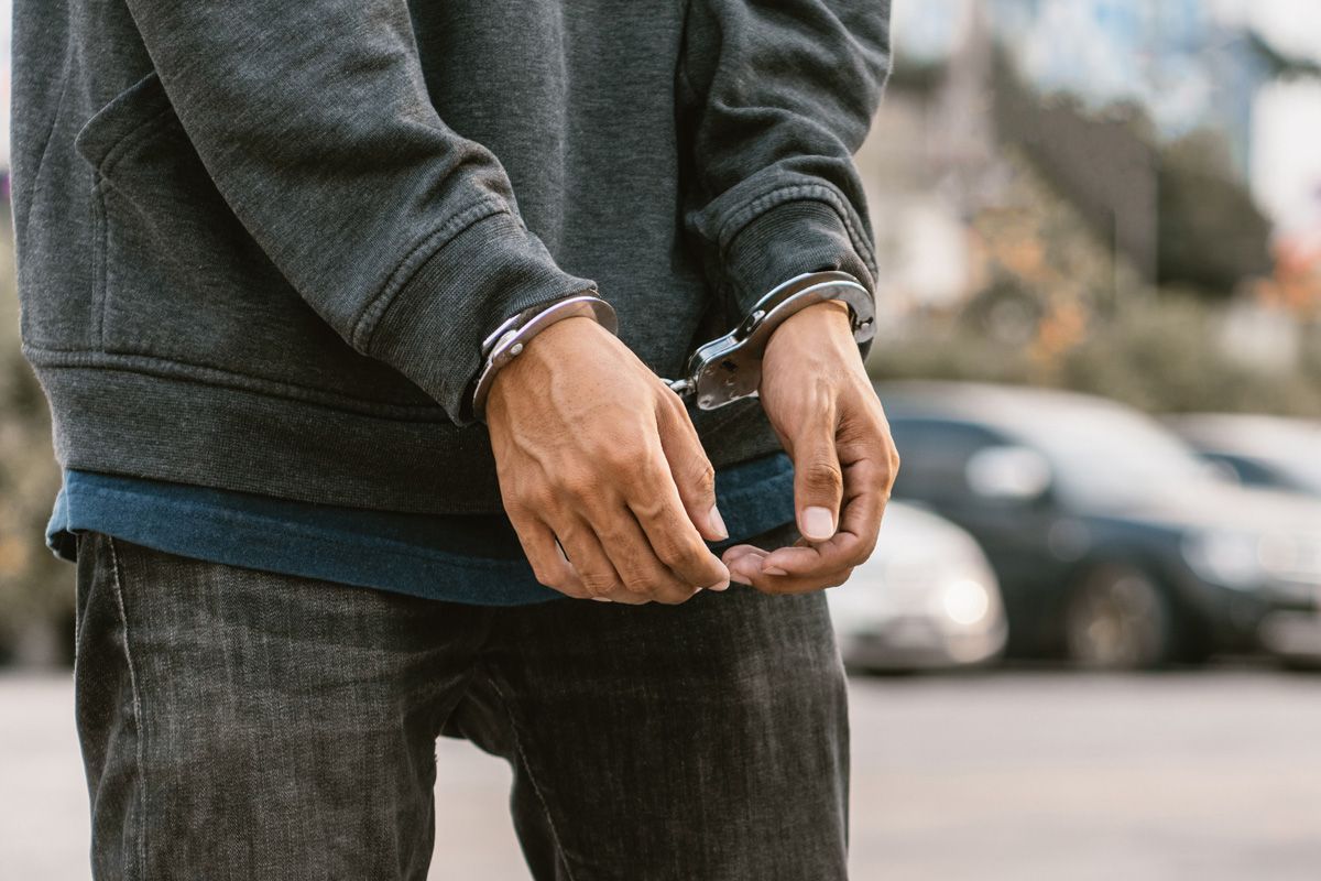 Handcuffed Male Hands — Yuba City, CA — Law Office of Geoffrey J. Heitman