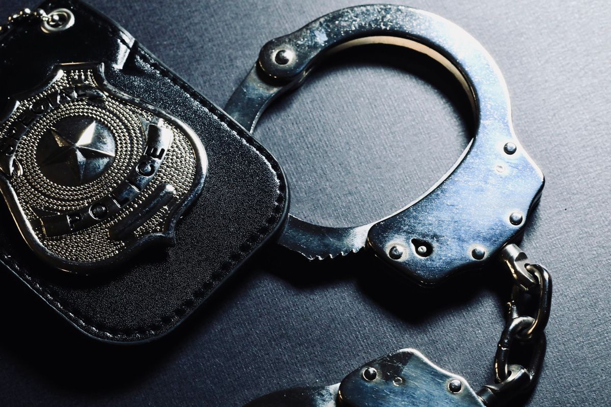 Police Badge and Handcuffs — Yuba City, CA — Law Office of Geoffrey J. Heitman