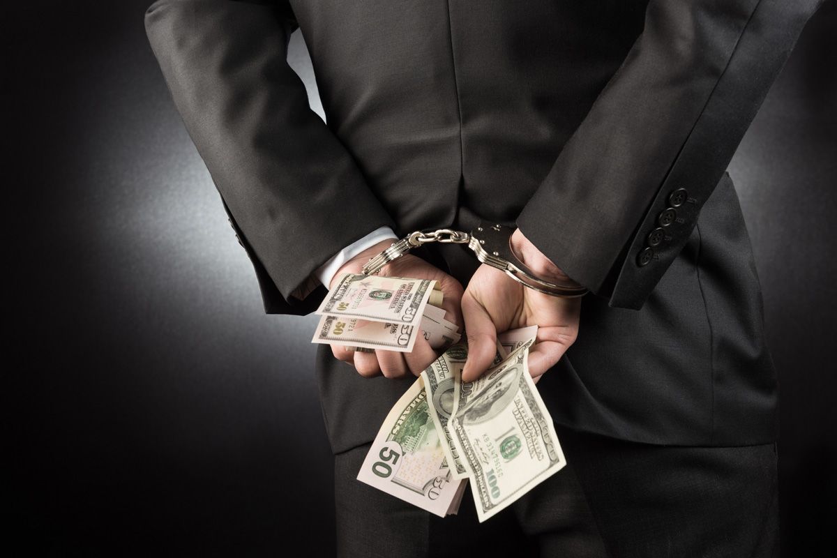 Businessman Handcuffed with Dollar — Yuba City, CA — Law Office of Geoffrey J. Heitman Businessman Handcuffed with Dollar — Yuba City, CA — Law Office of Geoffrey J. Heitman