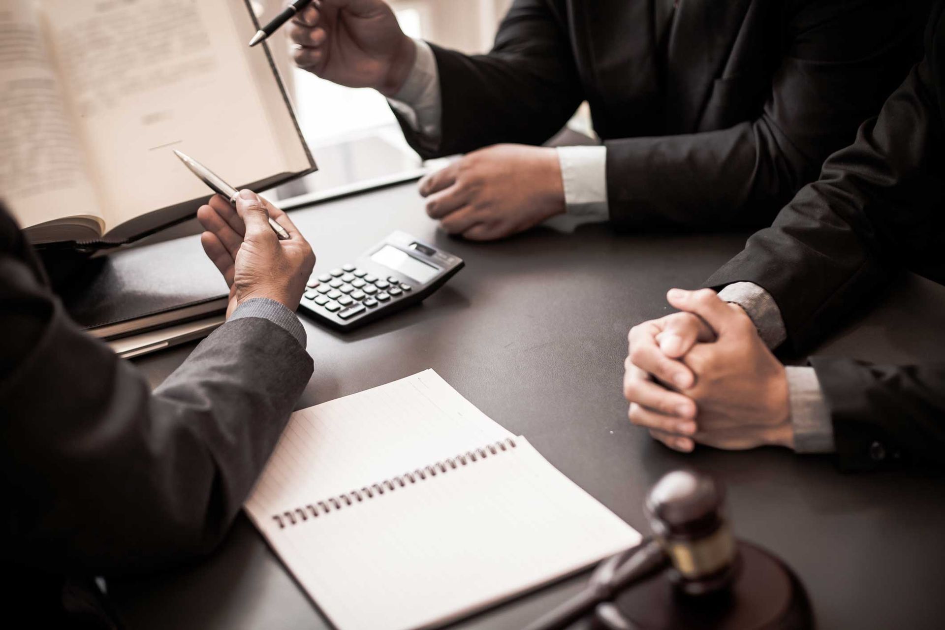 Group of business people and lawyers discussing contract papers. Group of business people and lawyers discussing contract papers.
