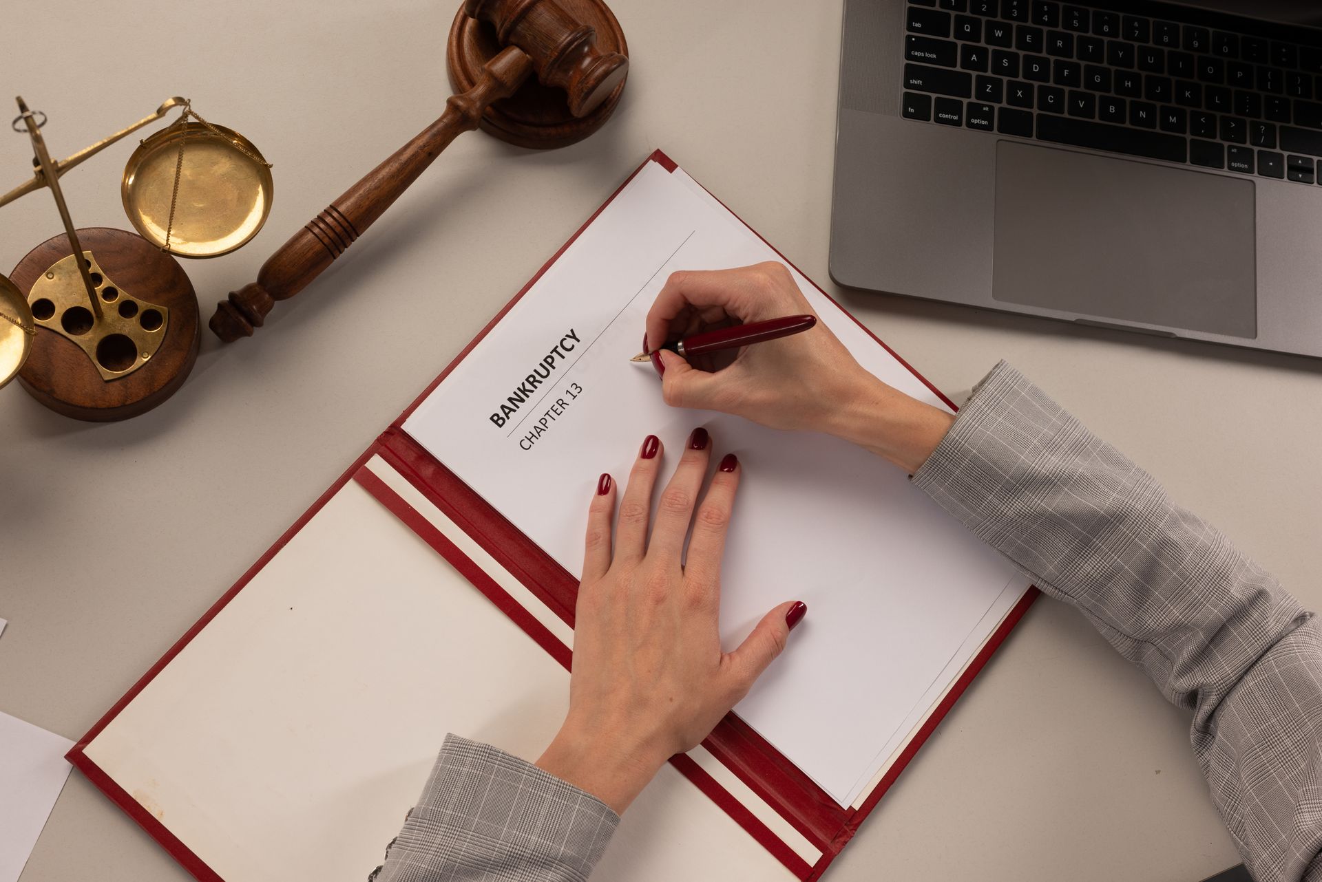 A woman is writing in a document. A woman is writing in a document.