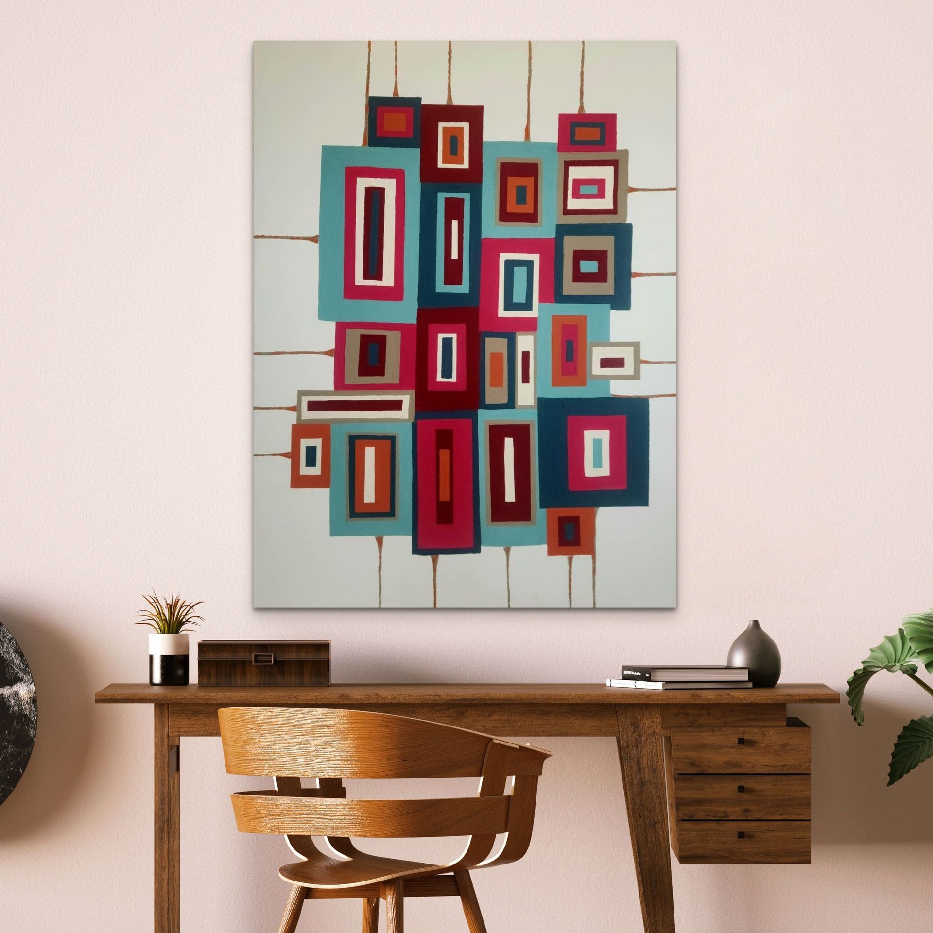 An abstract painting of stacked, colorful rectangles with vertical lines hanging above a wooden desk and chair.