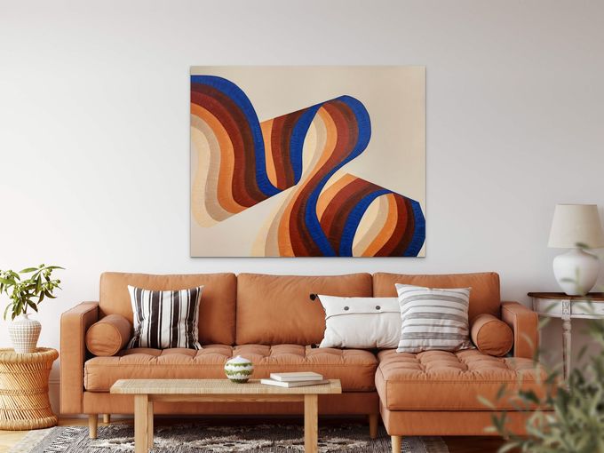 A modern living room features a tan sectional sofa, a coffee table, and abstract wall art with wavy orange and blue lines.