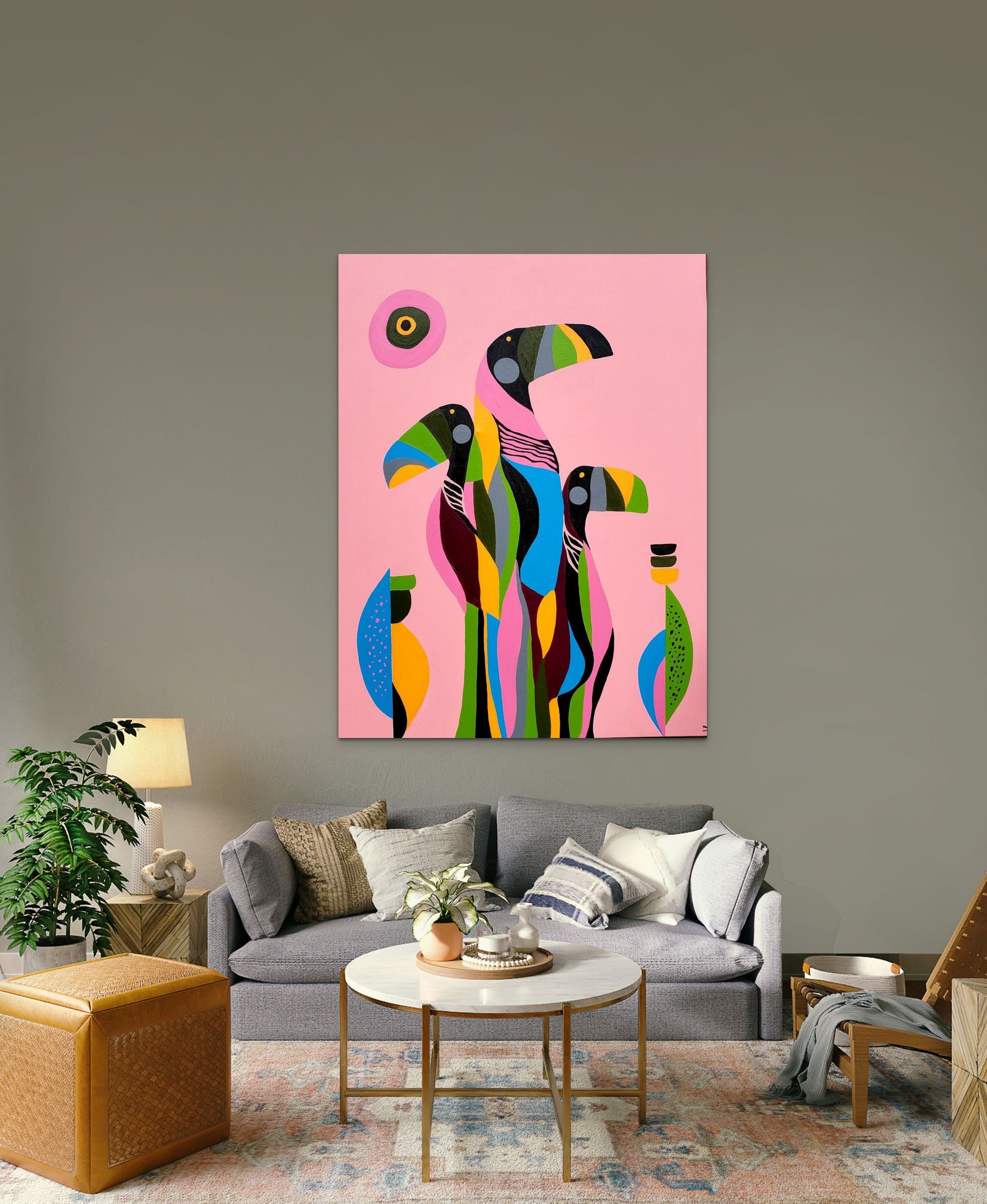 A modern living room features a colorful abstract painting of birds on a light pink background hanging above a gray sofa.