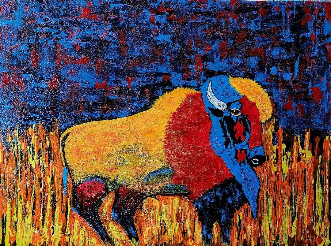 An expressionist painting of a buffalo in yellow, red, and blue, standing in tall, fiery-colored grass against a dark sky.