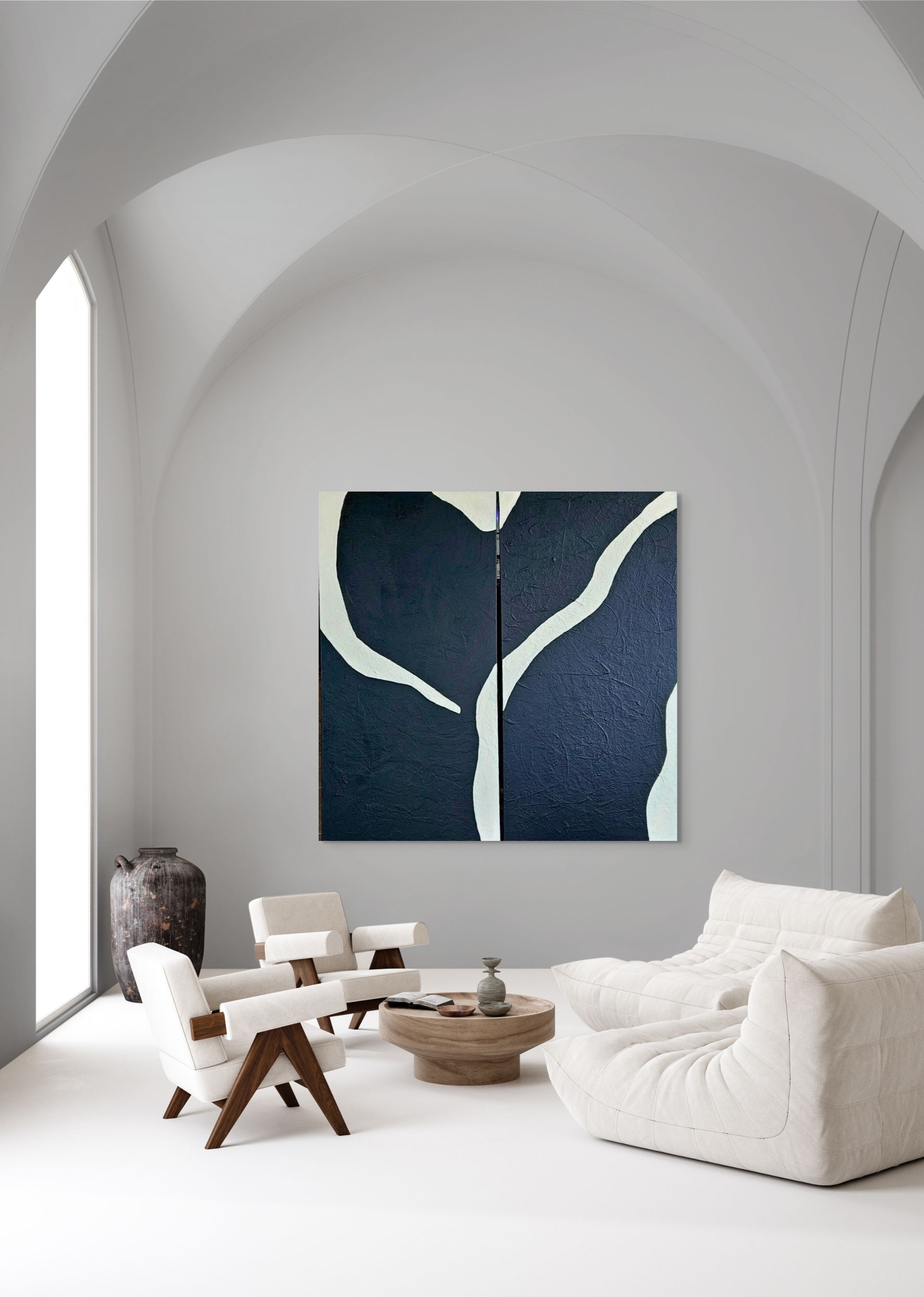 A gray sofa in a living room sits beneath two dark blue abstract paintings with white curved lines.