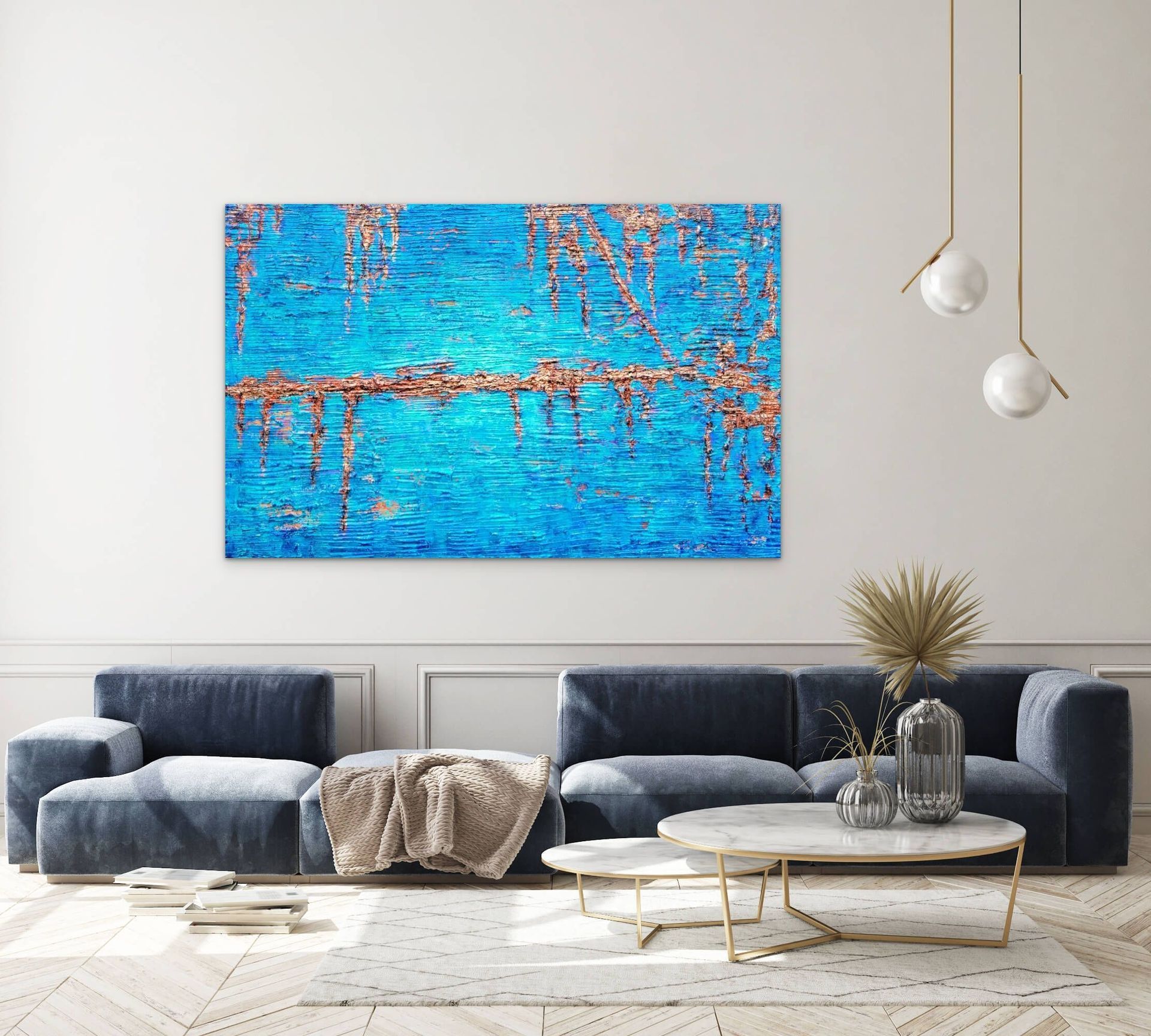 A large textured blue and copper abstract painting hangs on a wall above a contemporary navy sofa and two coffee tables.