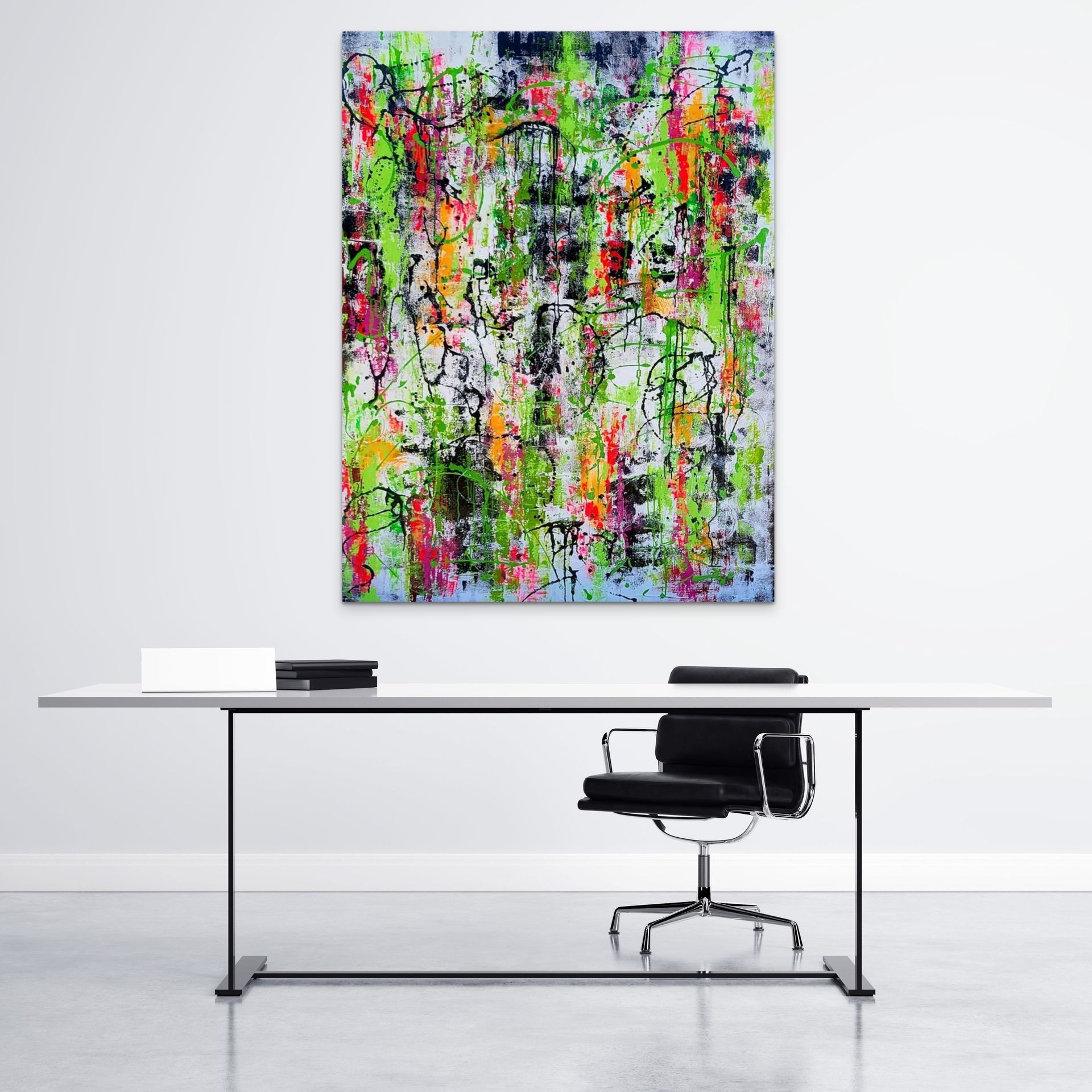A colorful, abstract painting hangs above a sleek white desk with a modern black office chair in a minimalist room.
