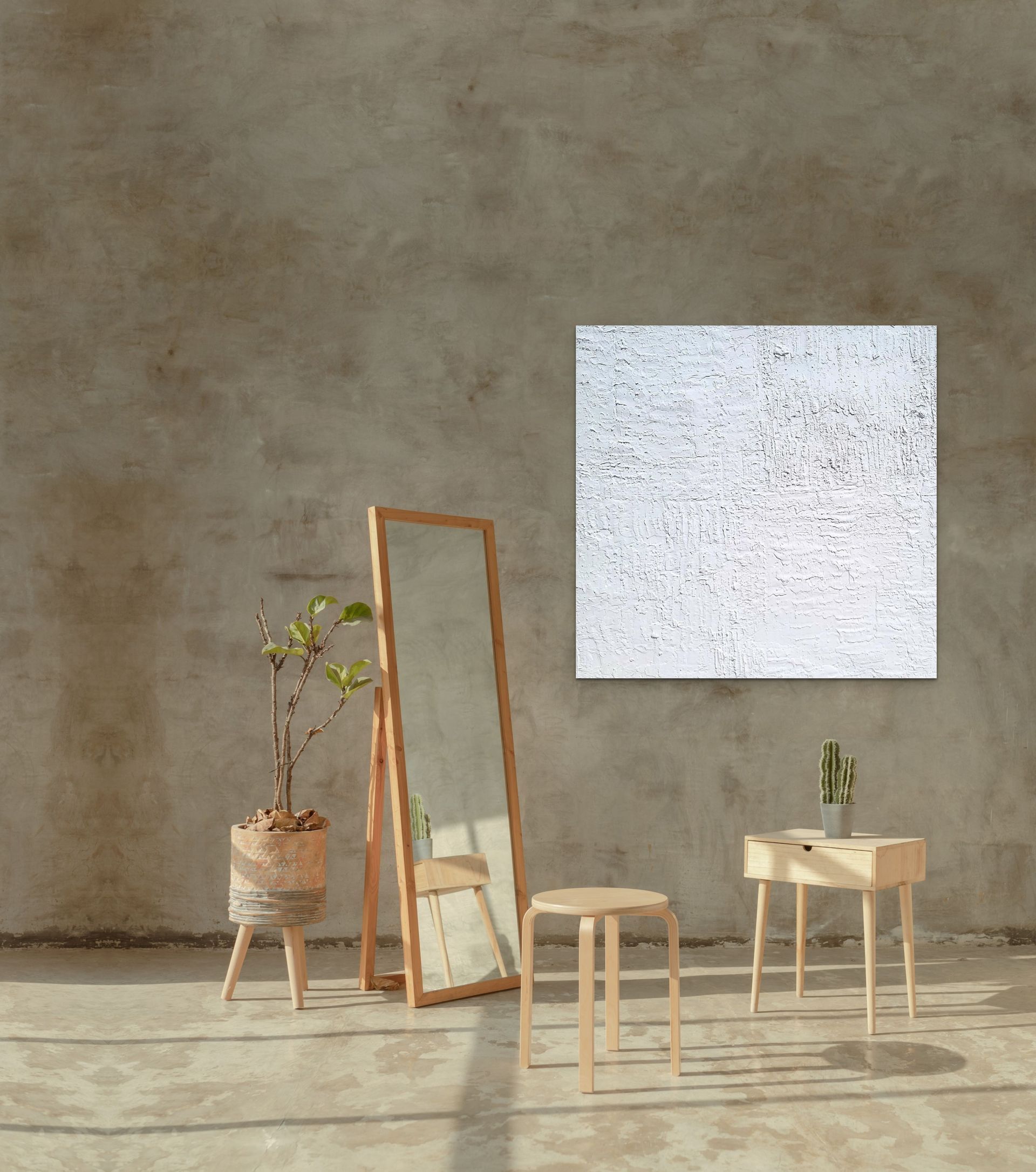 A textured white painting hangs on a concrete wall above a minimalist wooden side table, a tall mirror, and a potted plant.