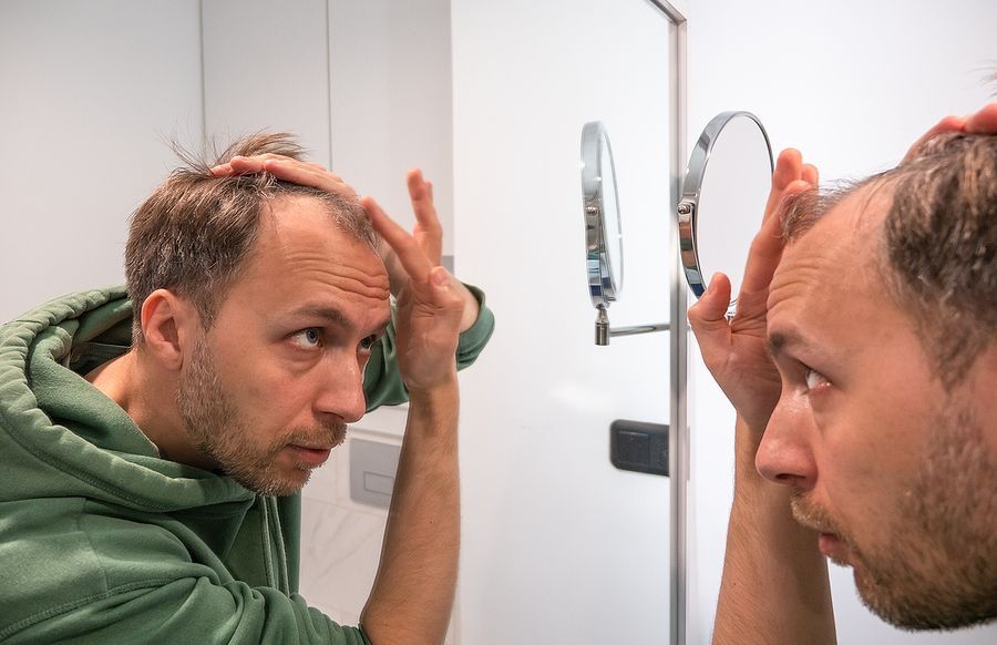 a man looking at his reflection in a mirror