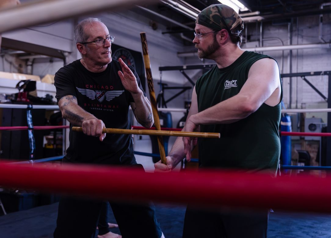 Two men are fighting in a boxing ring and one of them is wearing adidas shorts