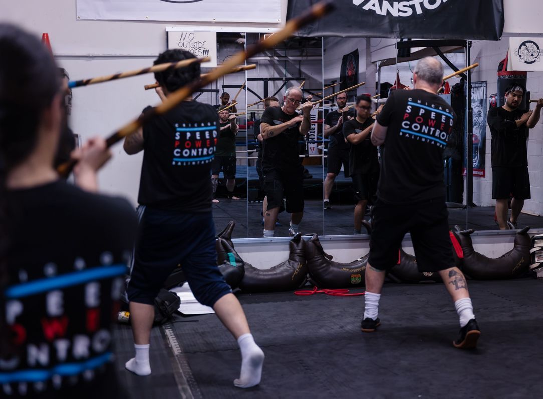 A group of people are practicing martial arts in a gym.