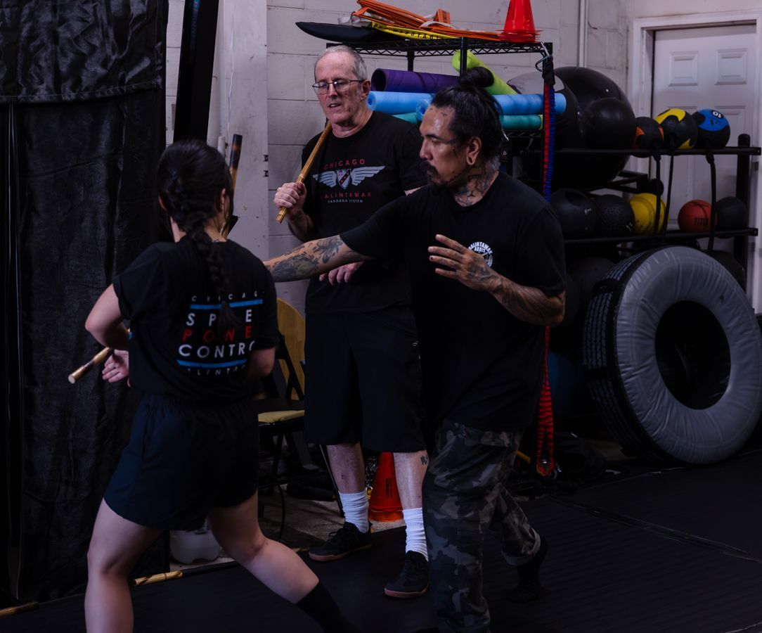 A group of men are practicing martial arts on a blue mat.