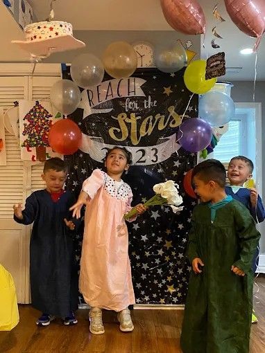 Children posing at a “Fall in the Stars 2023” birthday party with balloons and star decorations