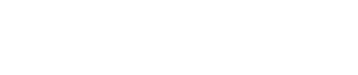 A black and white photograph of an empty, narrow corridor with white walls and a tile floor, featuring a solitary doorway.