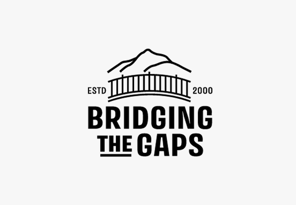 A logo featuring a mountain outline above a bridge, with the text 