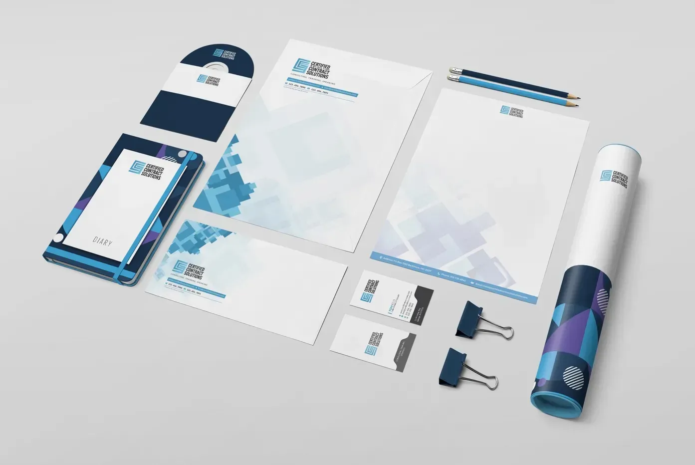 Corporate branding stationery set featuring business cards, letterheads, and notebooks in blue and white geometric patterns.