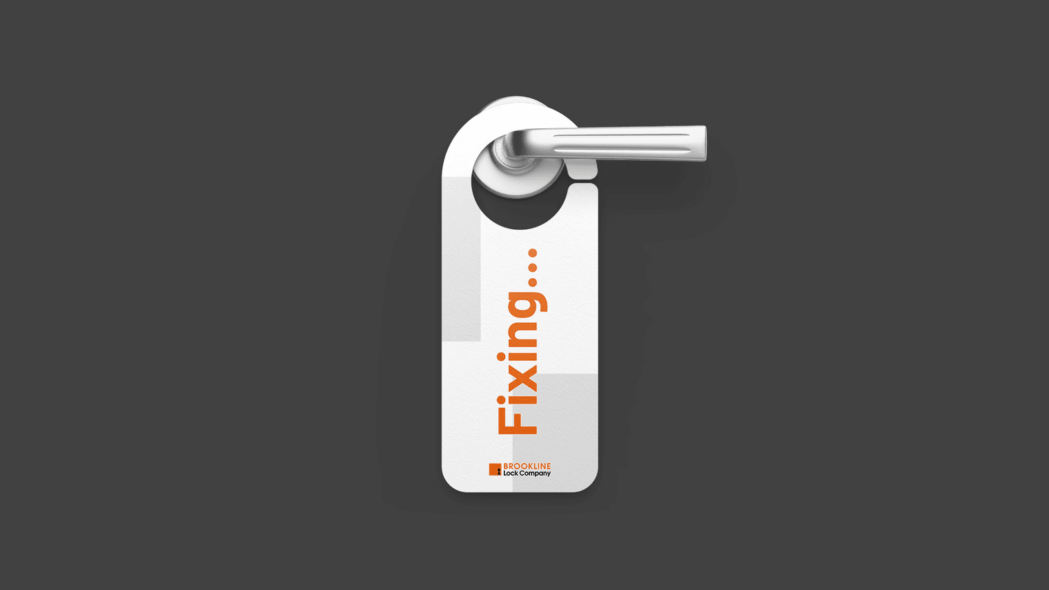 A white, glossy door hanger on a door handle with the orange word