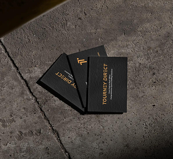 Three black business cards with gold text, featuring the logo