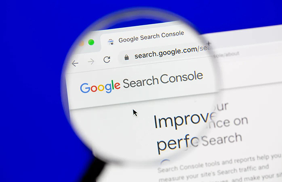 A magnifying glass focuses on the Google Search Console website displayed on a screen against a solid blue background.