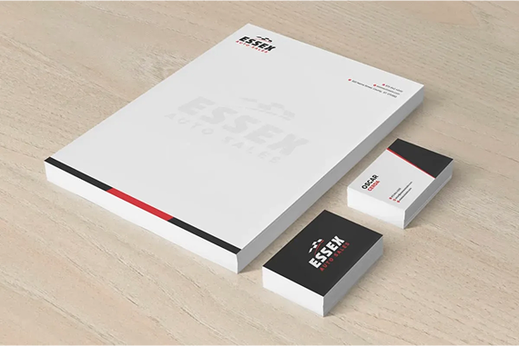 A stack of letterhead paper and two business cards featuring the
