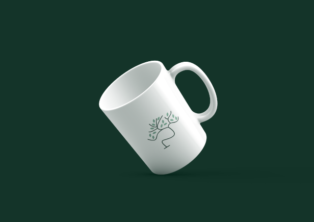 A white mug tilted against a dark green background, featuring a simple black line drawing of a tree on its surface.