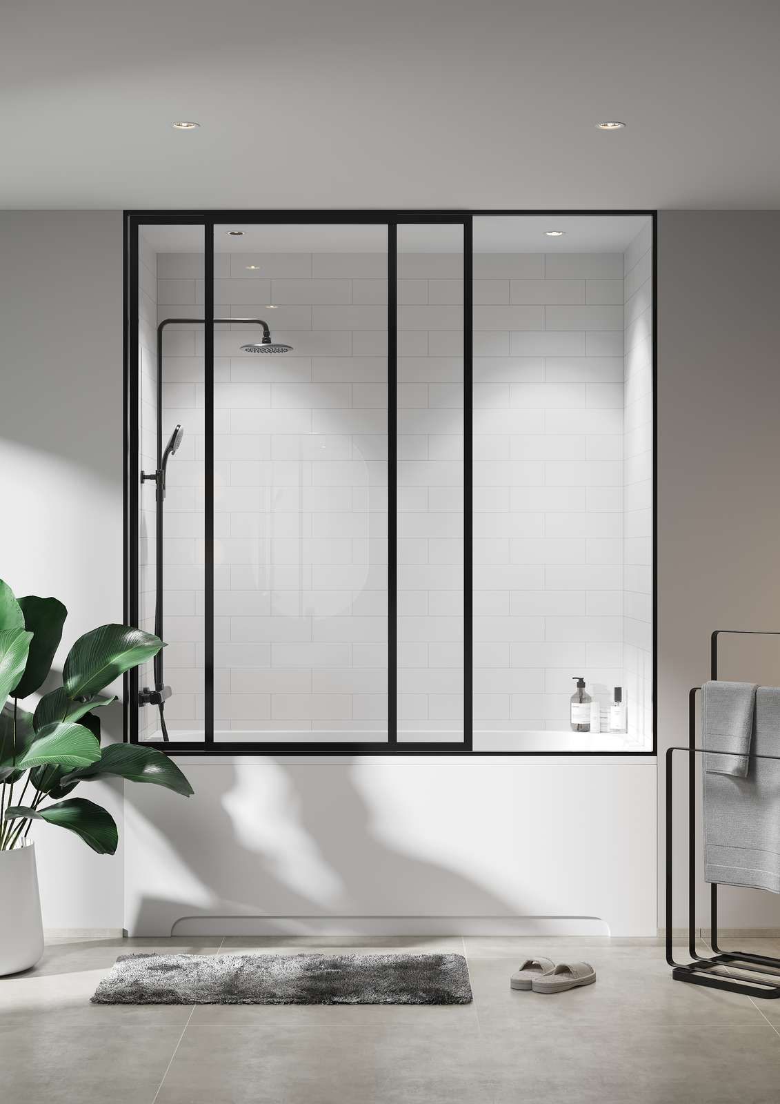 Black-framed shower enclosure over a white tub. Black fixtures. White tiled wall. Modern bathroom setting.