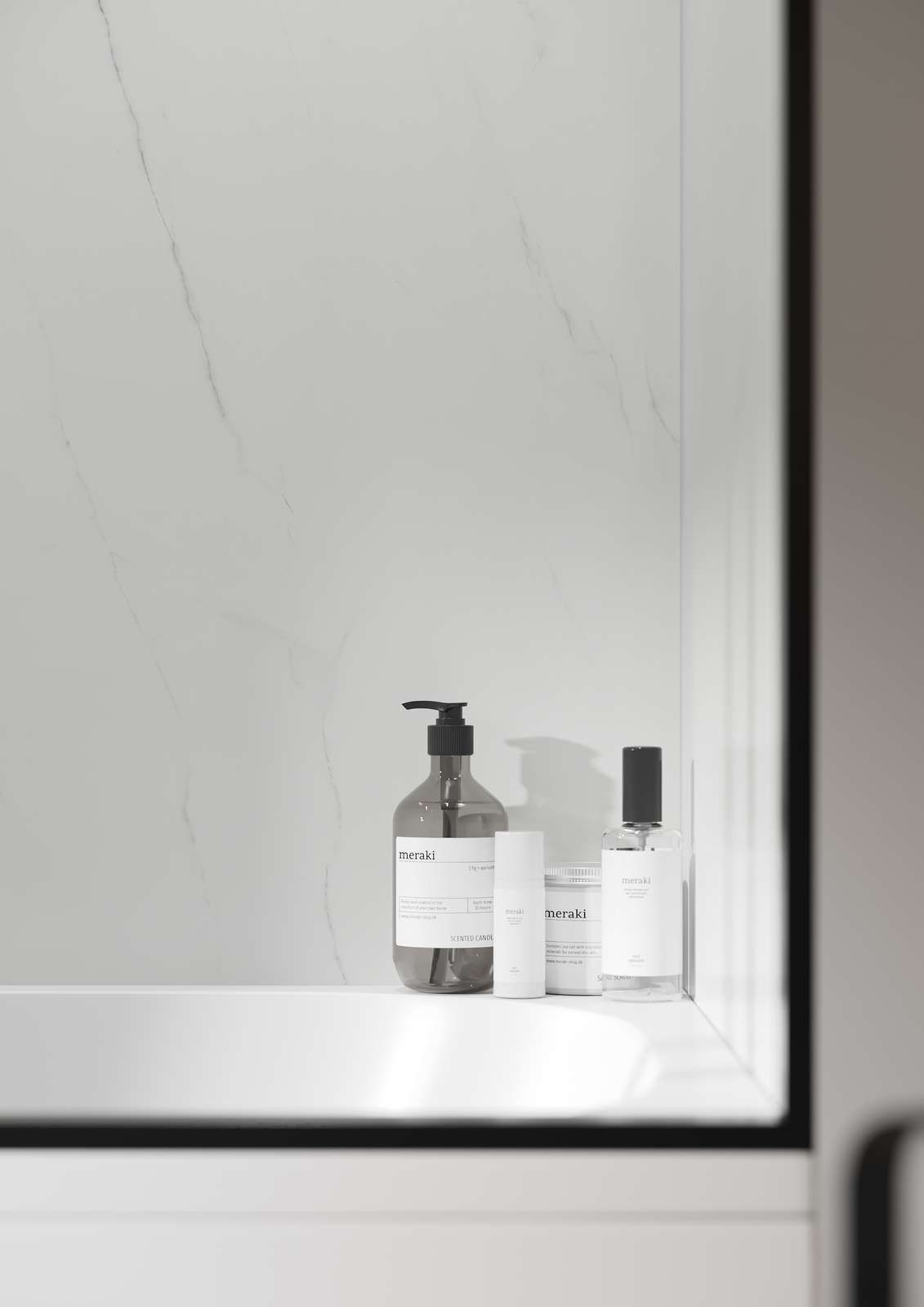 Bottles of toiletries on a white shelf against a marble wall.