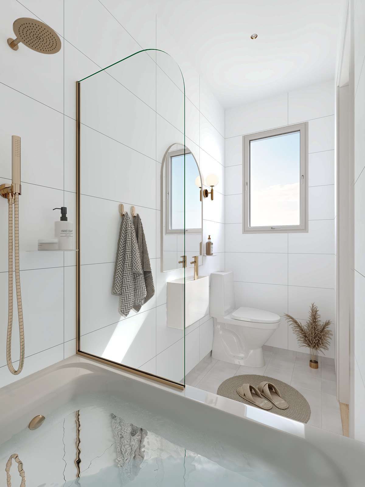 Modern white bathroom with tub, shower, sink, toilet, and arched mirror. Golden fixtures and neutral accents.