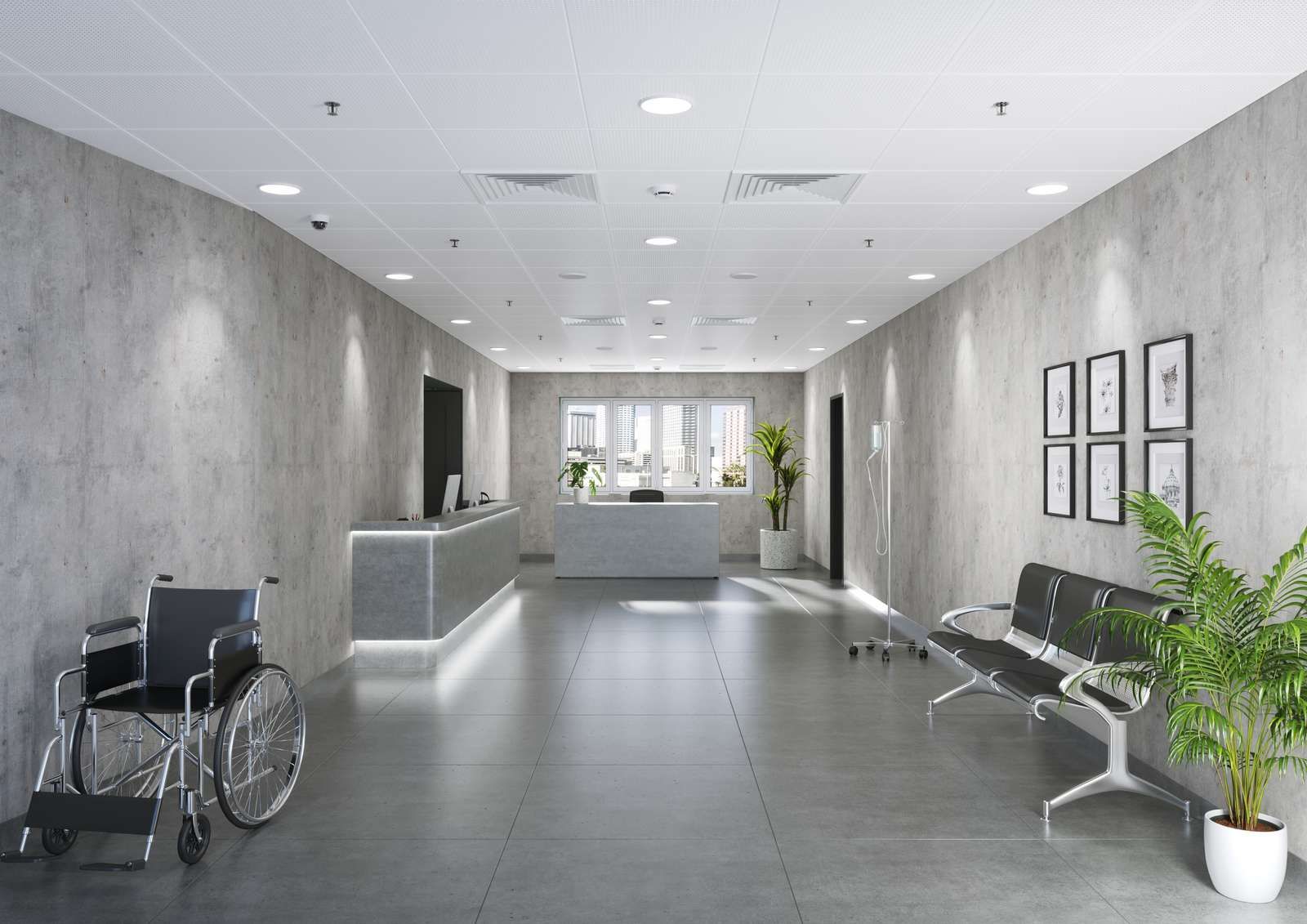 Modern clinic lobby with concrete walls, reception desk, wheelchair, and seating.