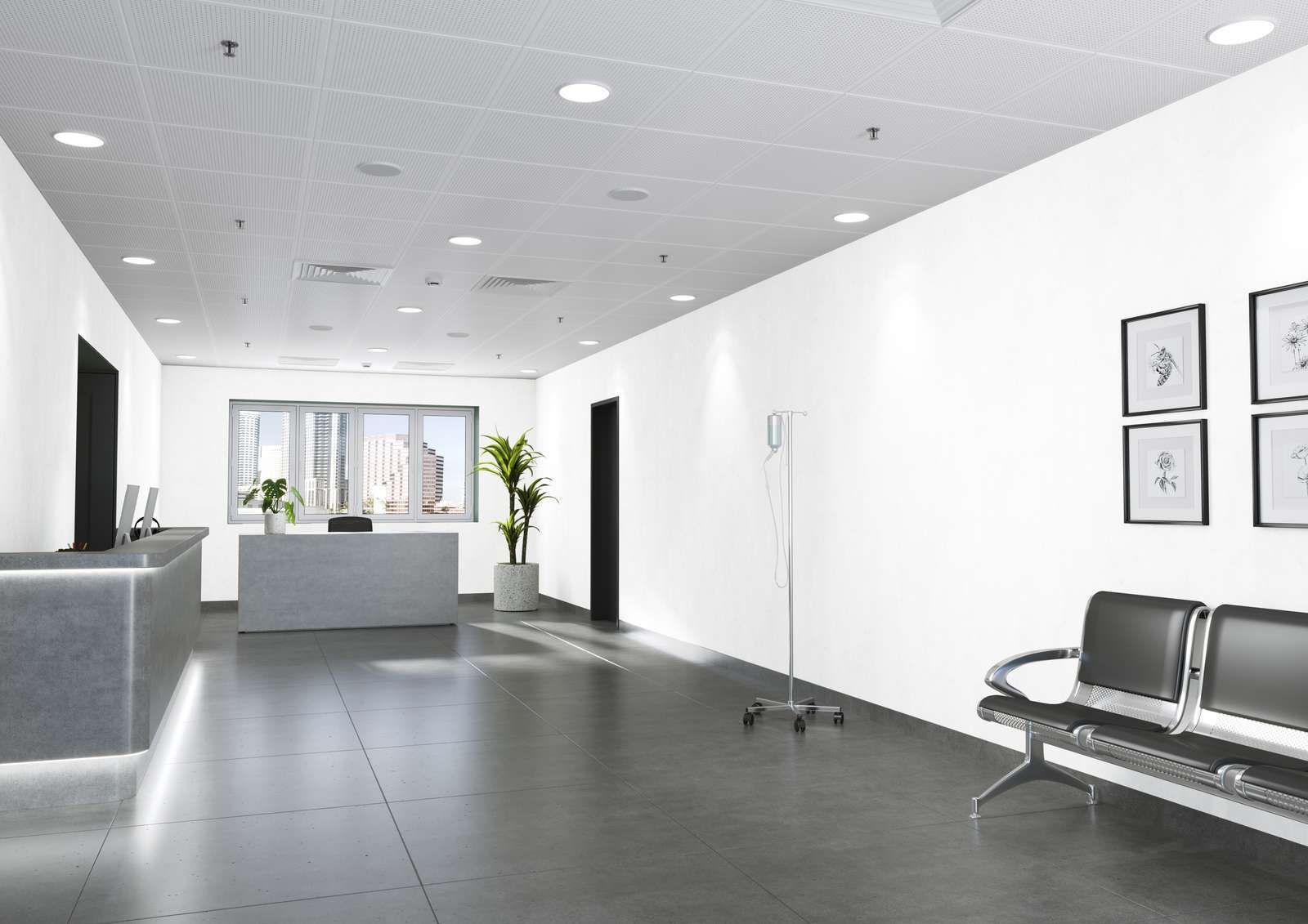 Modern, bright medical office waiting area with a reception desk, chairs, and framed artwork.