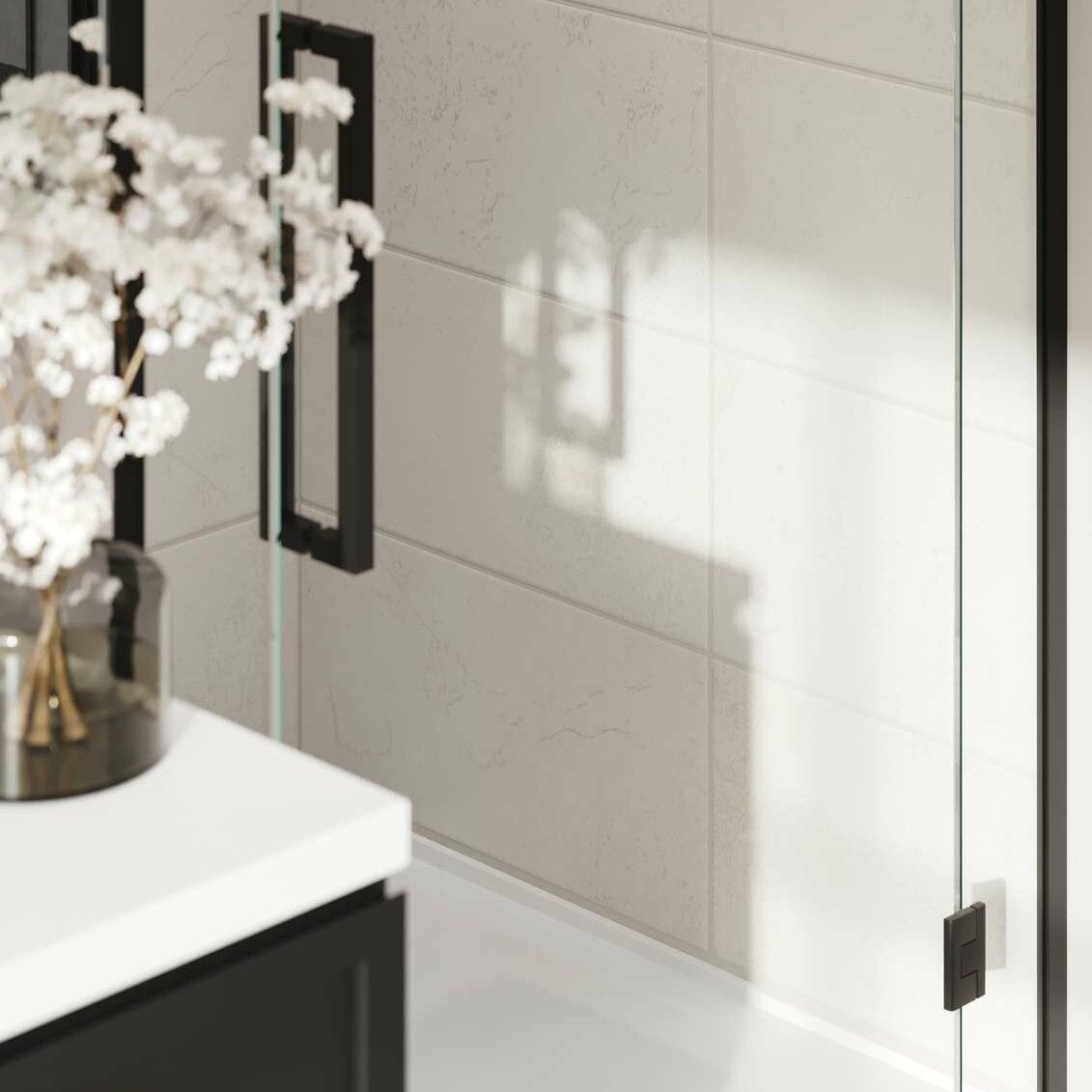 Bathroom interior with a shower, a vanity with flowers in a vase, and a black trim.
