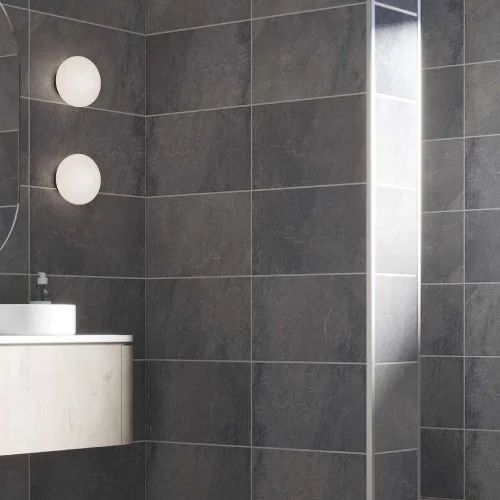 Dark tiled bathroom with round wall lights, a floating vanity, and a mirror.