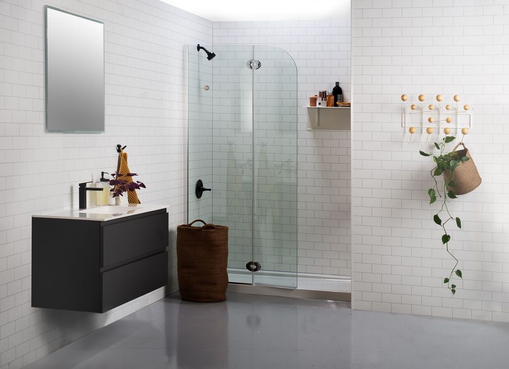 Modern bathroom with floating vanity, glass shower enclosure, and neutral tones.