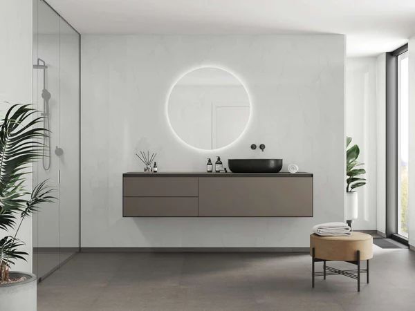 Modern bathroom with floating vanity, circular mirror, and large window. Neutral tones, minimalist design.