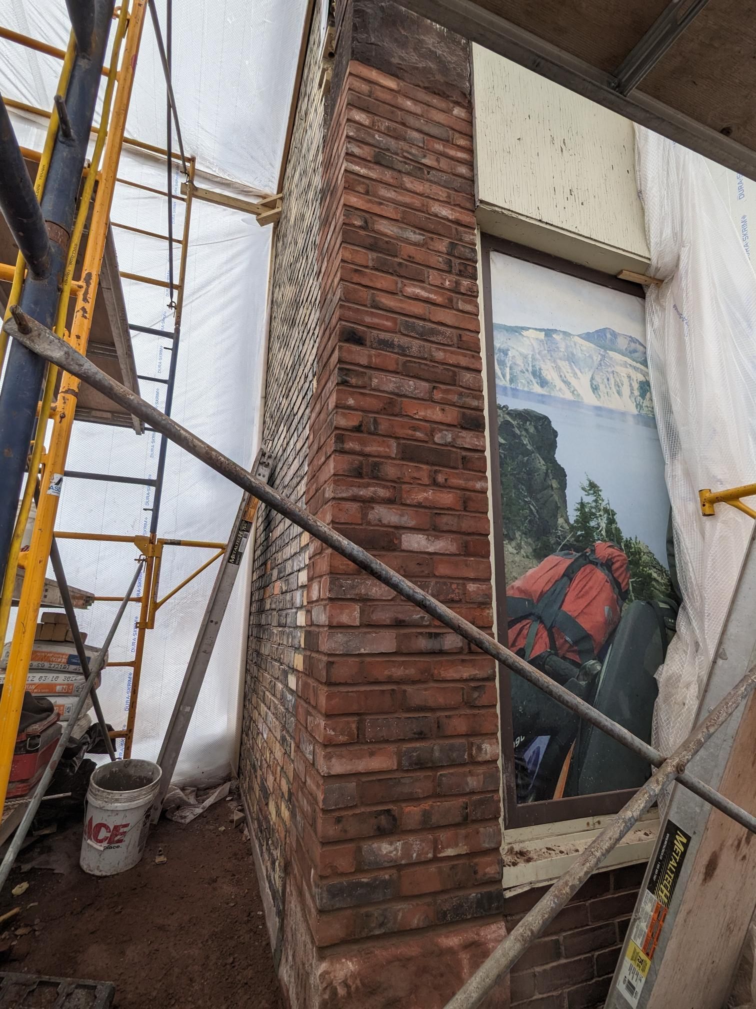 A brick wall with a picture of a backpack on it.