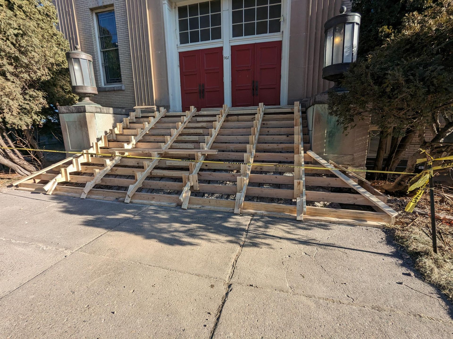 A wooden ramp is being built in front of a building.