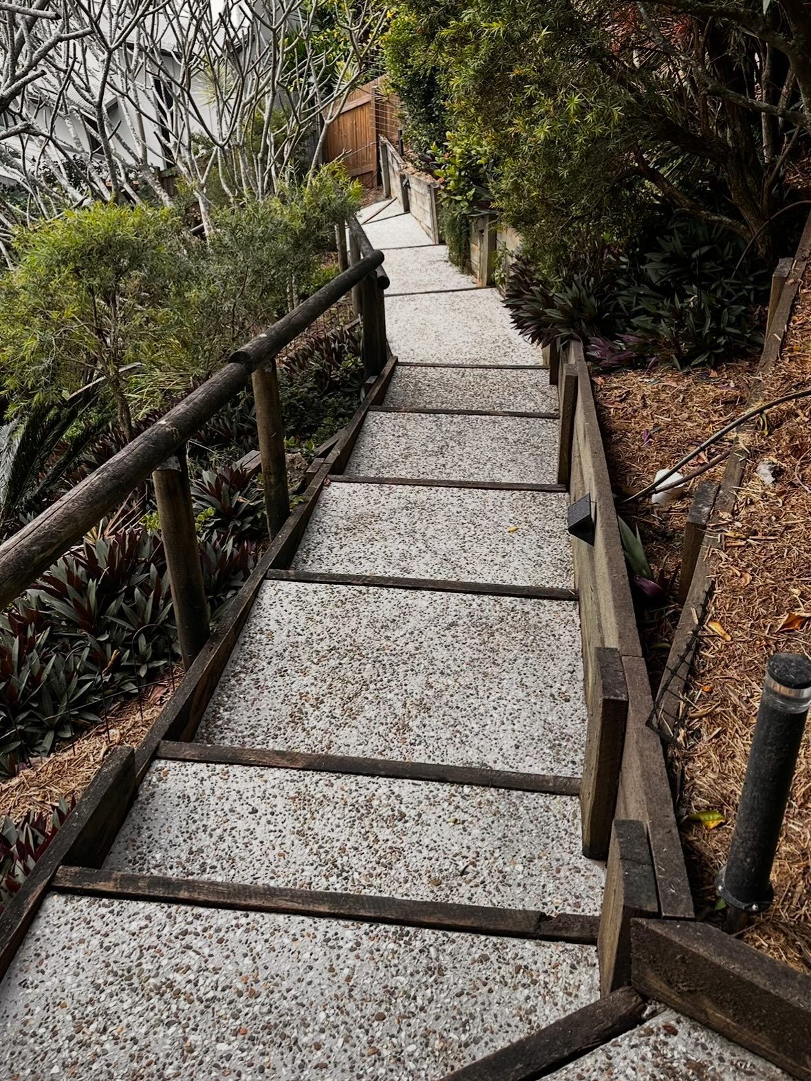 A Steep, Downward-sloping Outdoor Staircase With Gravel Steps — Coastal Pressure Solutions in Oxenford, QLD
