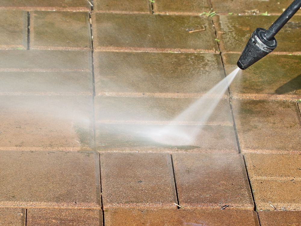 Power Washer Spraying Water — Coastal Pressure Solutions in Paradise Point, QLD