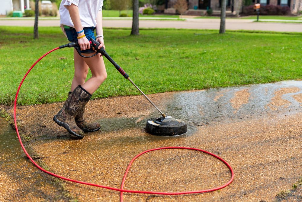 Person Using a Surface Cleaner — Coastal Pressure Solutions in Oxenford, QLD