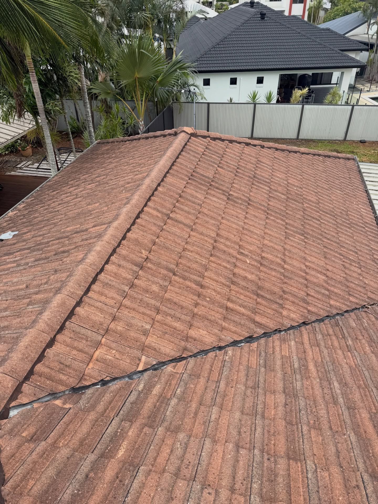 High-angle View of a Weathered Red Tiled Roof — Coastal Pressure Solutions in Oxenford, QLD